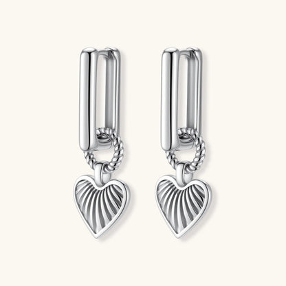 Platinum-plated 925 sterling silver rectangular hoop earrings with twisted ring connector and ribbed heart charm pendant.